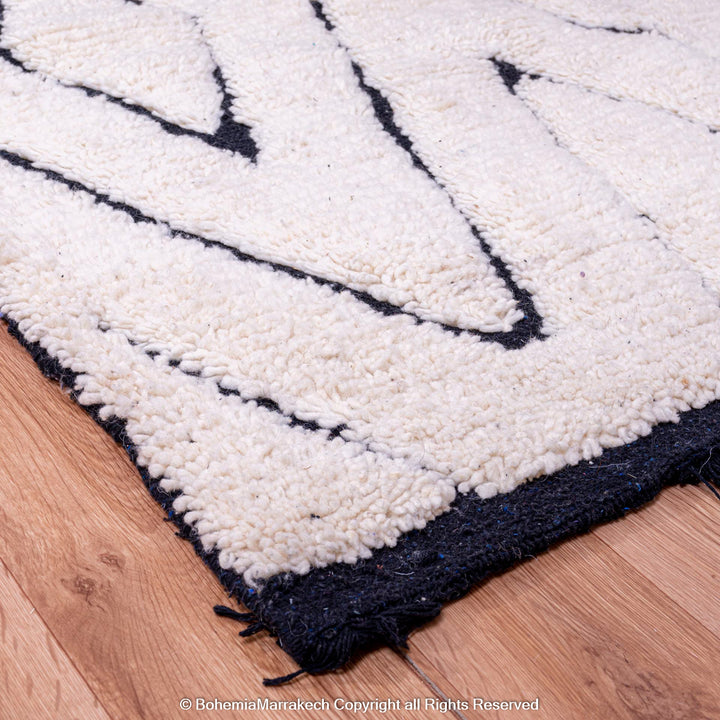 Handmade black and white diamond Moroccan wool rug, featuring a traditional Berber design, ideal for contemporary or boho interiors.