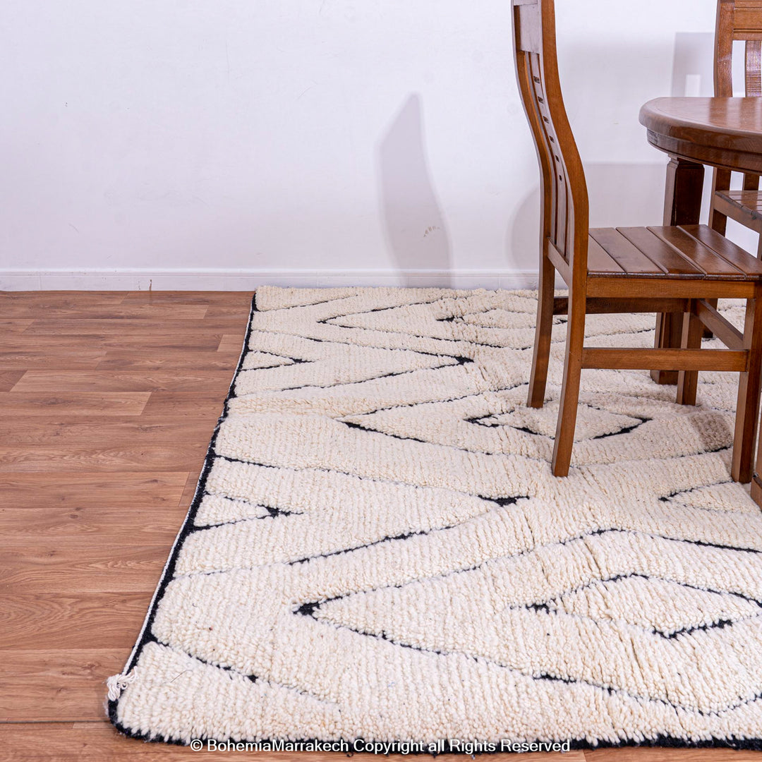 Handmade black and white diamond Moroccan wool rug, traditional Berber design, perfect for modern or boho interiors.