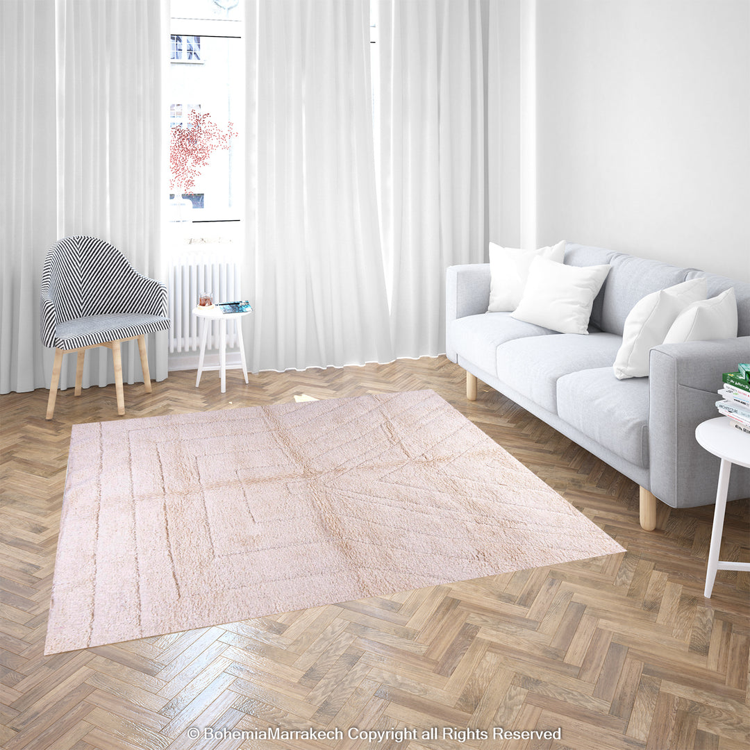 Handmade cream Moroccan Berber rug in a serene living room, showcasing geometric patterns on hardwood floors.
