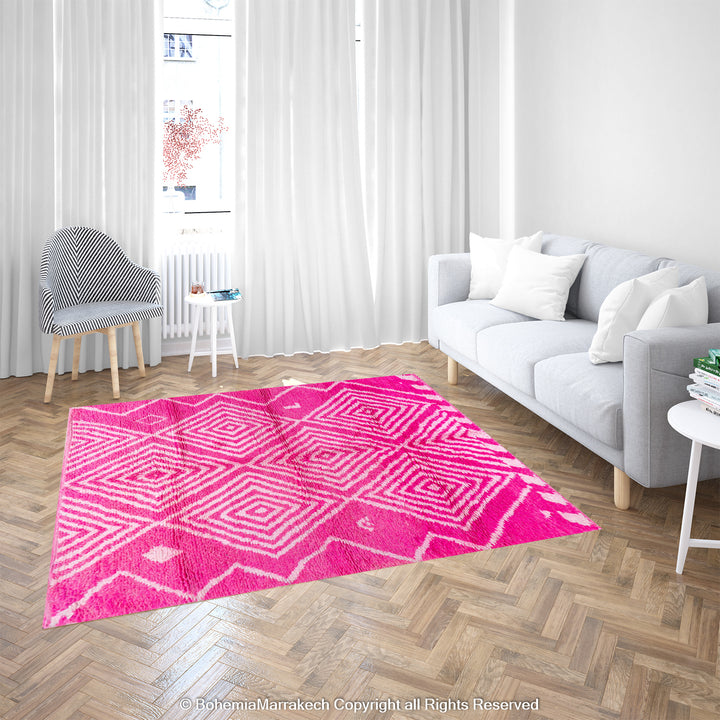 Pink Moroccan Berber rug with white diamond motifs in a modern living room, handmade wool carpet from Morocco.
