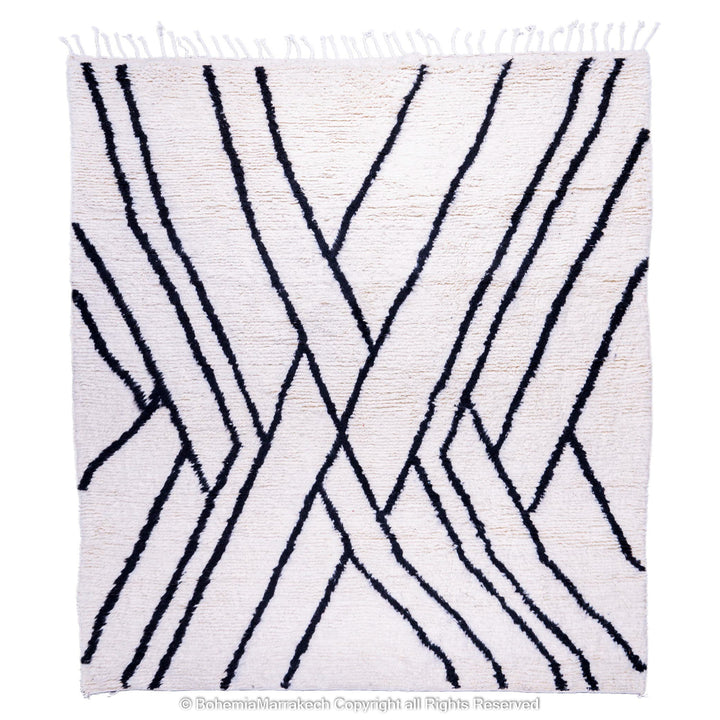 Black and white Beni Ourain Moroccan wool rug with abstract criss-cross pattern, ideal for modern interiors.