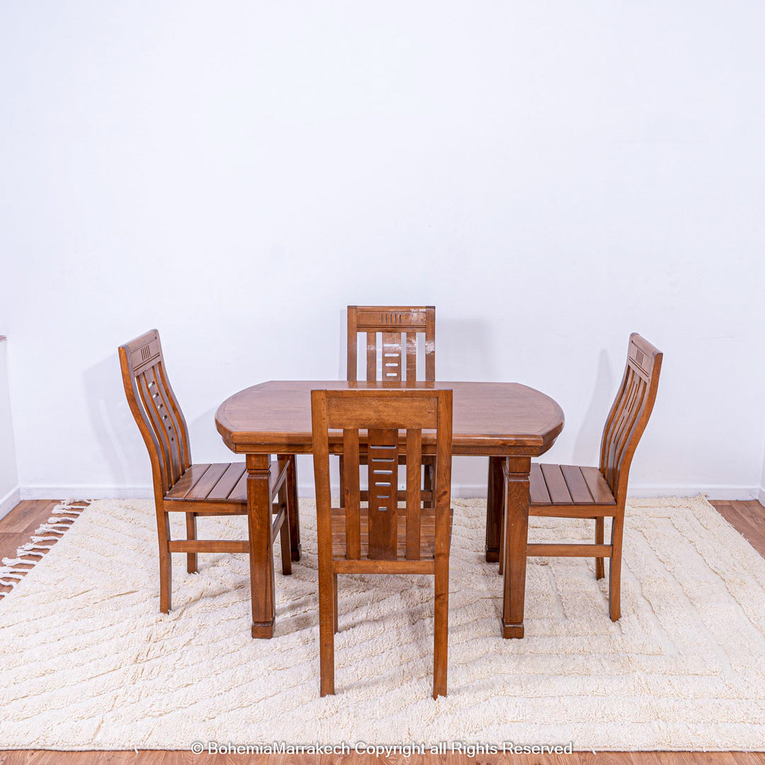 Wooden dining set on a white Moroccan rug with subtle V line texture, enhancing a minimalist interior design.