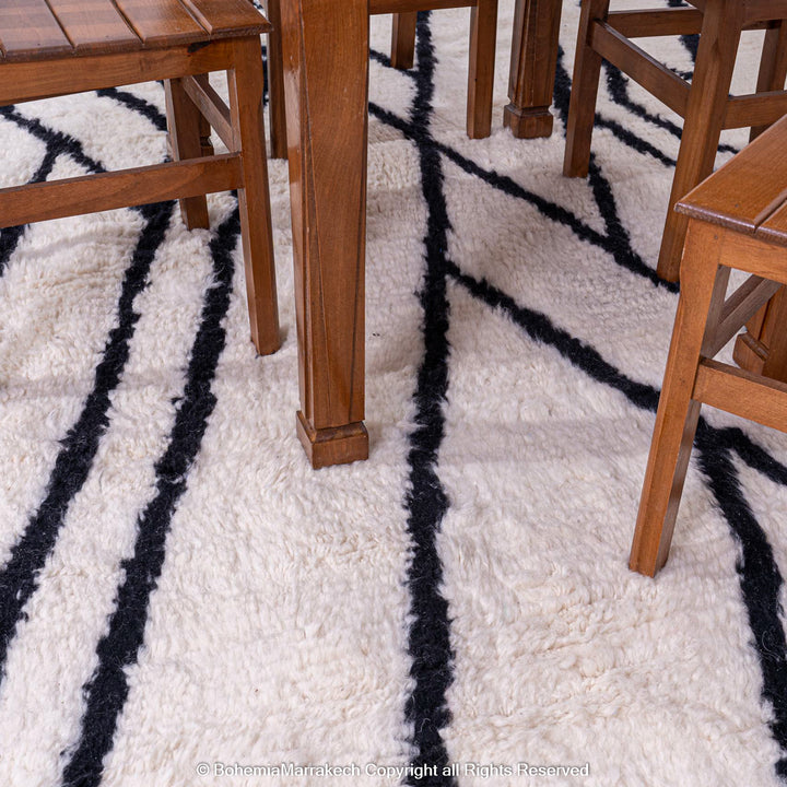 Black and White Moroccan Wool Rug with Geometric Pattern Under Wooden Dining Table