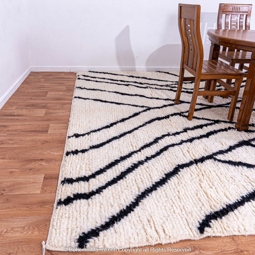 Black and white Beni Ourain Moroccan wool rug with abstract patterns, perfect for contemporary interiors.
