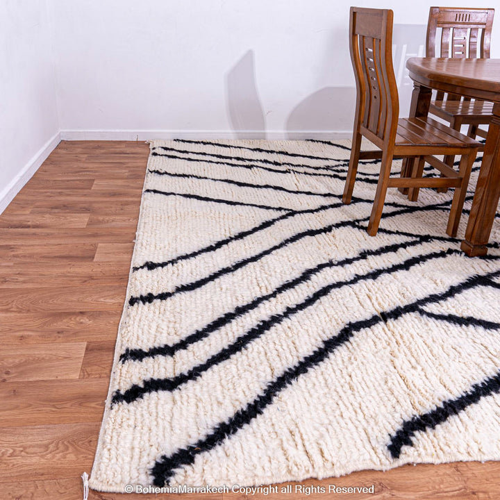 Black and white Beni Ourain Moroccan wool rug with abstract patterns, perfect for contemporary interiors.