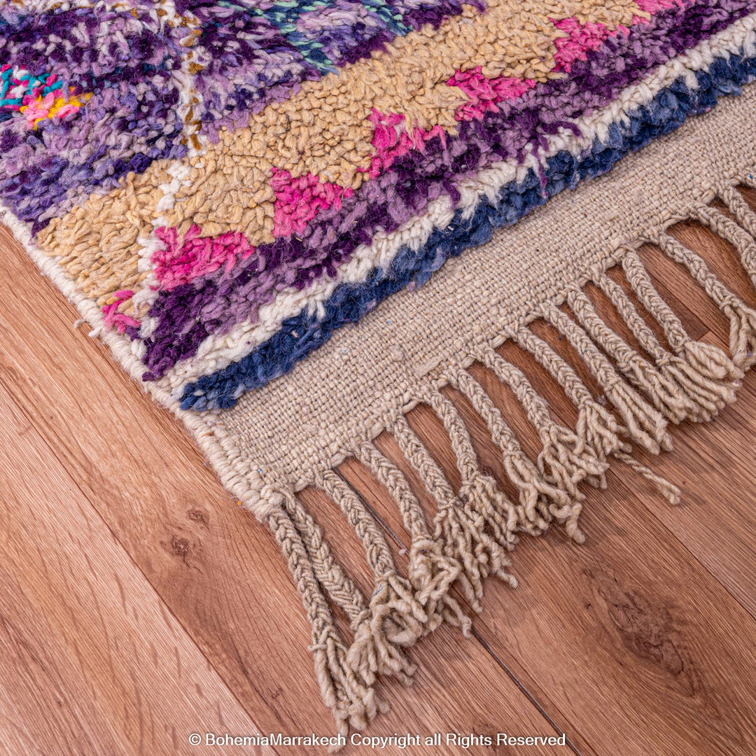 Colorful Moroccan Berber rug with purple and beige patterns, handmade wool carpet, traditional Moroccan style, home decor flooring.