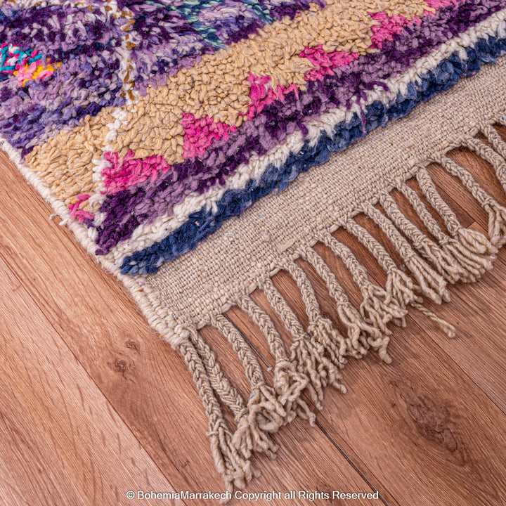 Colorful Moroccan Berber rug with purple and beige patterns, handmade wool carpet, traditional Moroccan style, home decor flooring.