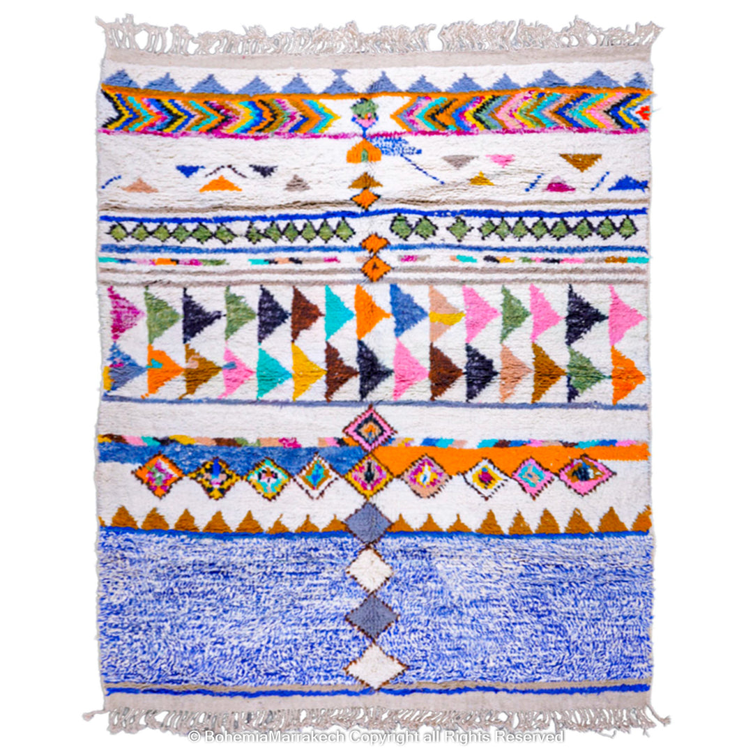 Colorful Moroccan wool rug with tribal motifs, geometric shapes, and bold colors on a white base. Handmade by Berber artisans.