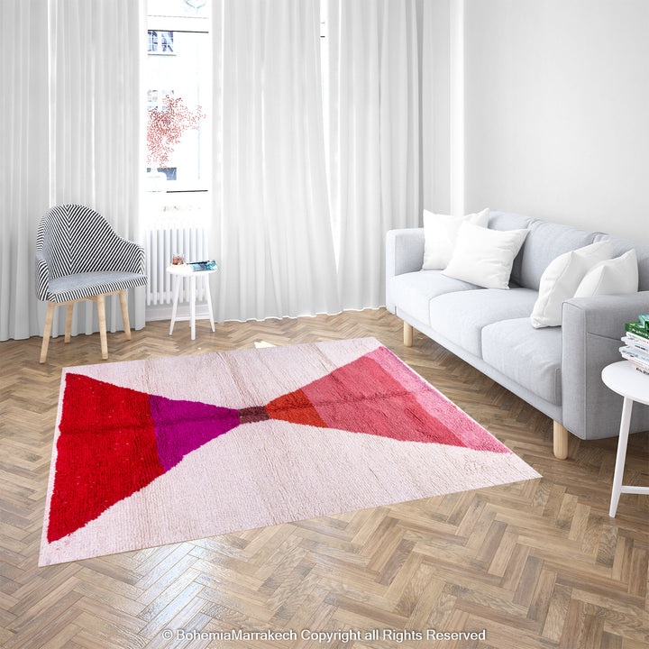 Handmade Red & Pink Hourglass Moroccan Wool Rug in modern living room, showcasing vibrant colors and Berber design.