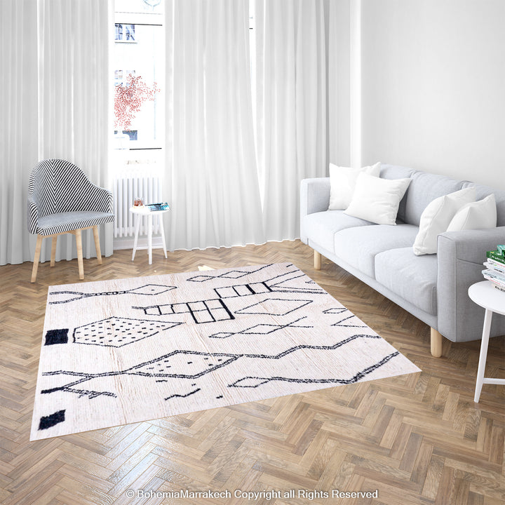 White Moroccan rug with abstract black diamond patterns in a modern living room; handcrafted Moroccan Berber rug.