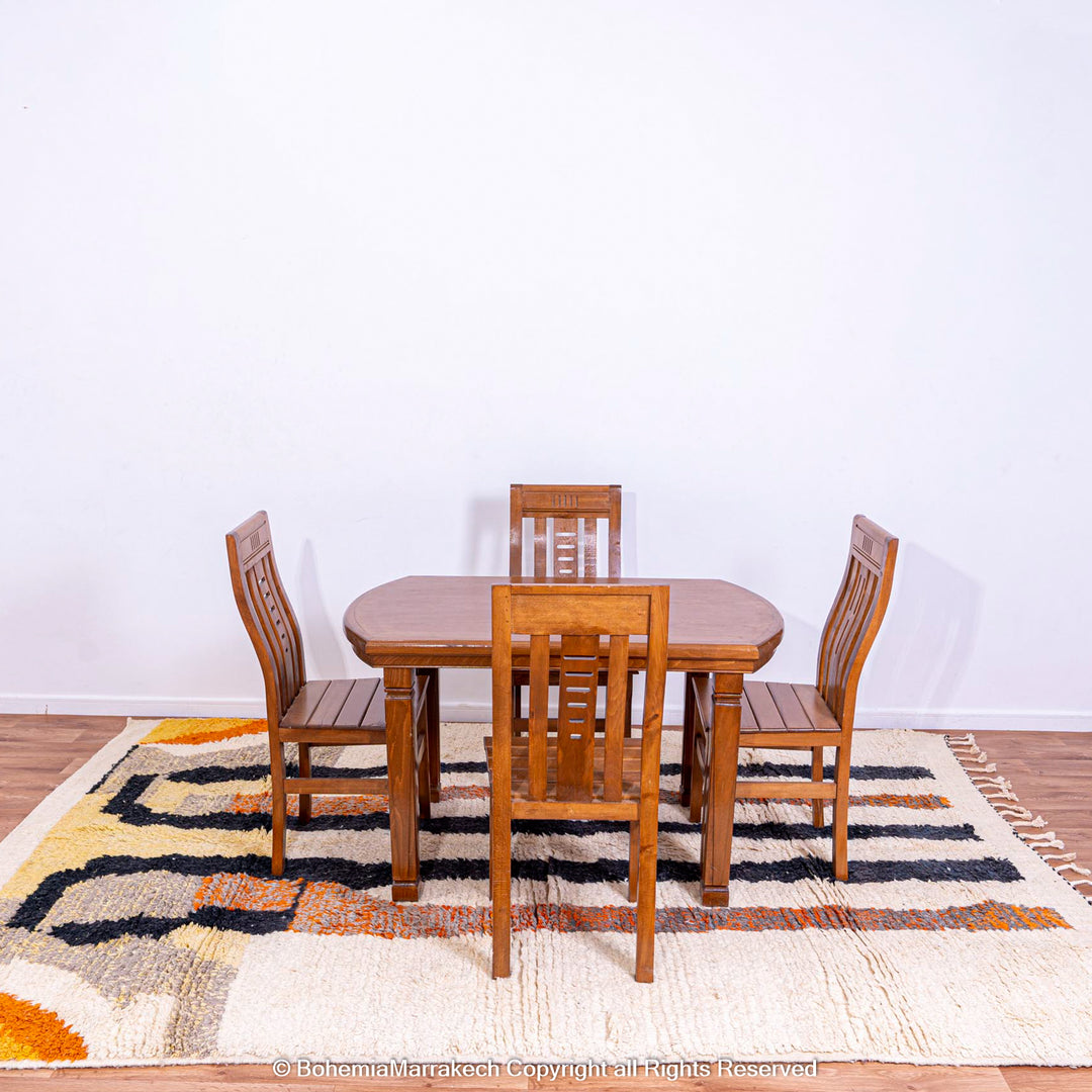 Striped Abstract Moroccan Rug under wooden dining set, featuring handmade wool craftsmanship and vibrant earthy tones.
