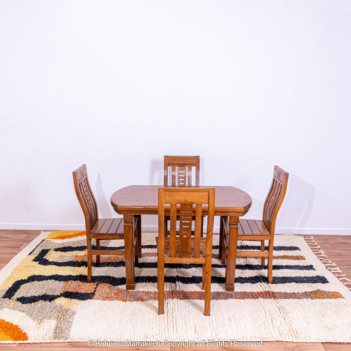 Striped Abstract Moroccan Rug under wooden dining set, featuring handmade wool craftsmanship and vibrant earthy tones.