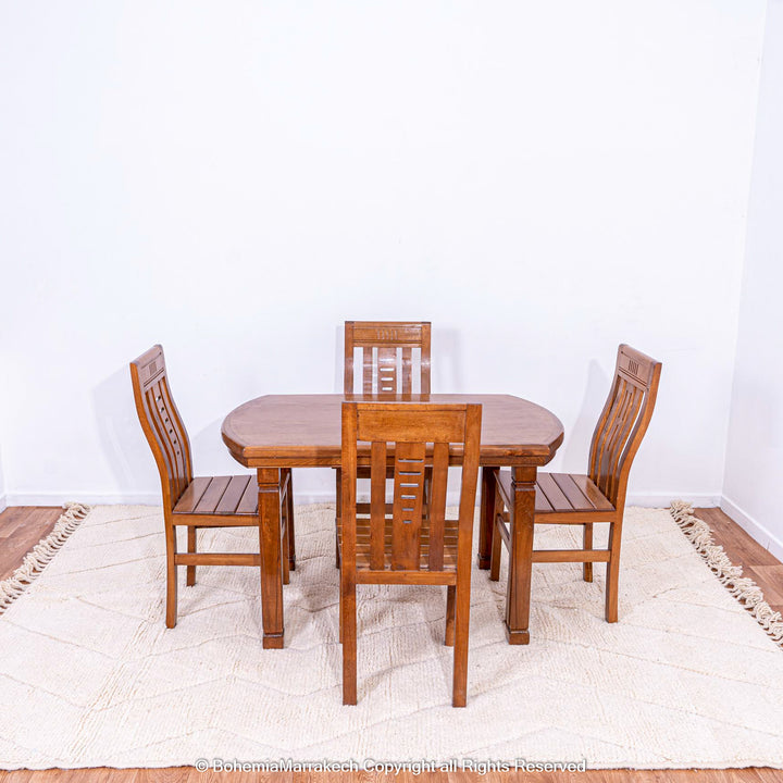 Wooden dining set on a white Moroccan rug with subtle zigzag design