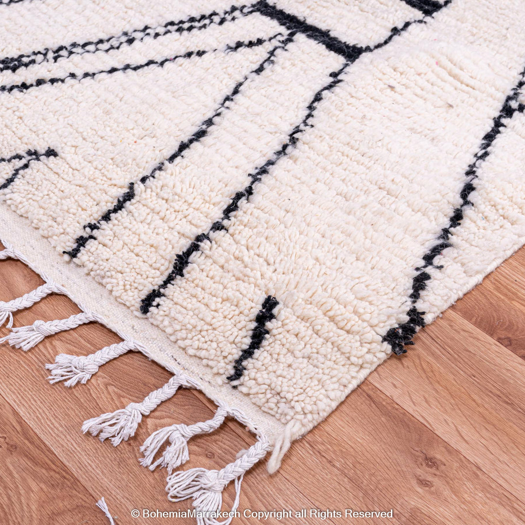 White Moroccan rug with an abstract diamond pattern, handwoven from natural wool. Ideal for modern or bohemian decor.
