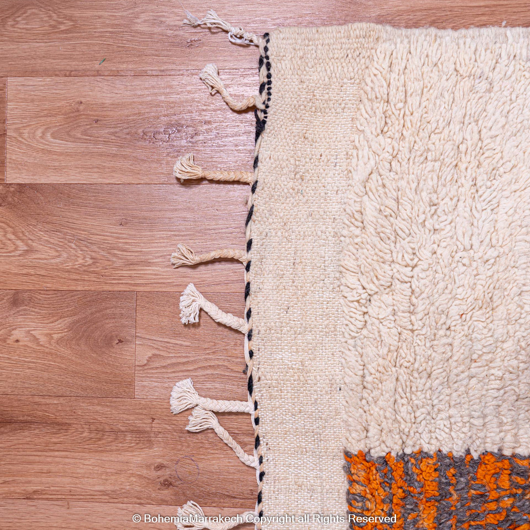 Handmade Striped Abstract Moroccan Rug with Wool Tassels, Black and Orange Accents on Cream Background, Berber Design