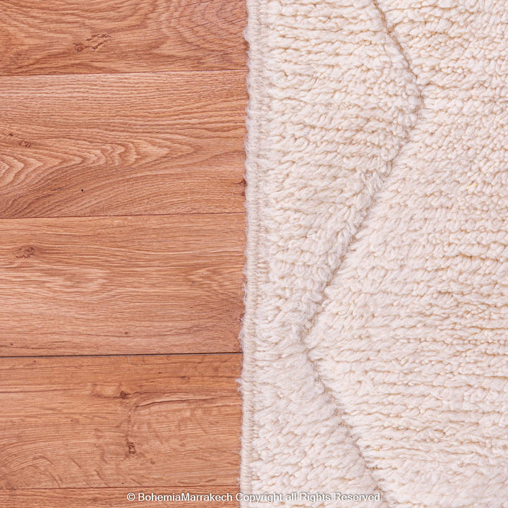 White Moroccan Rug with Zigzag Design on Wooden Floor - Moroccan Wool Rug