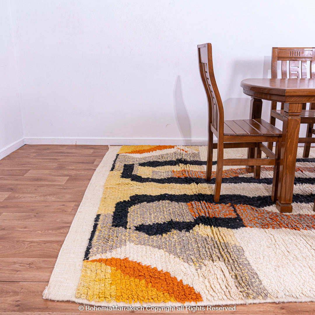 Striped Abstract Moroccan Wool Rug in a dining room with earthy tones and handmade design.