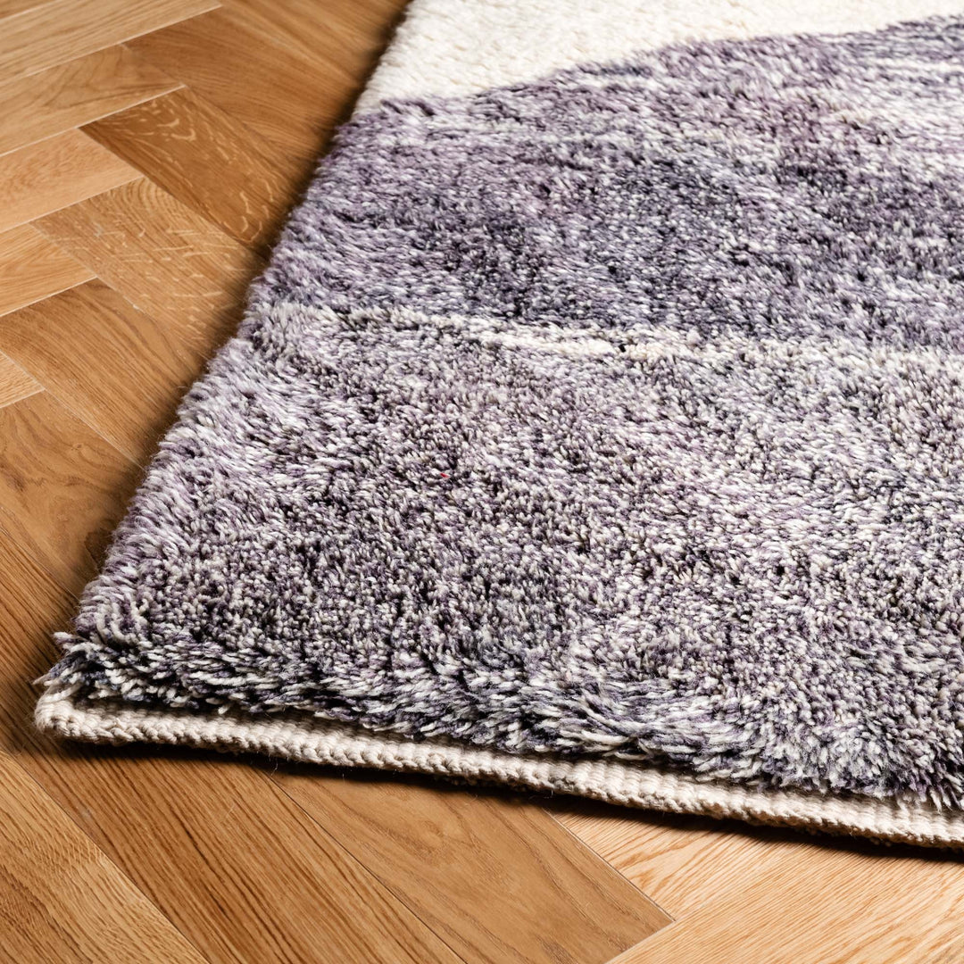 Close up of handmade Moroccan Beni Mrirt rug in wool, featuring geometric mountain designs in grey, perfect for modern decor.