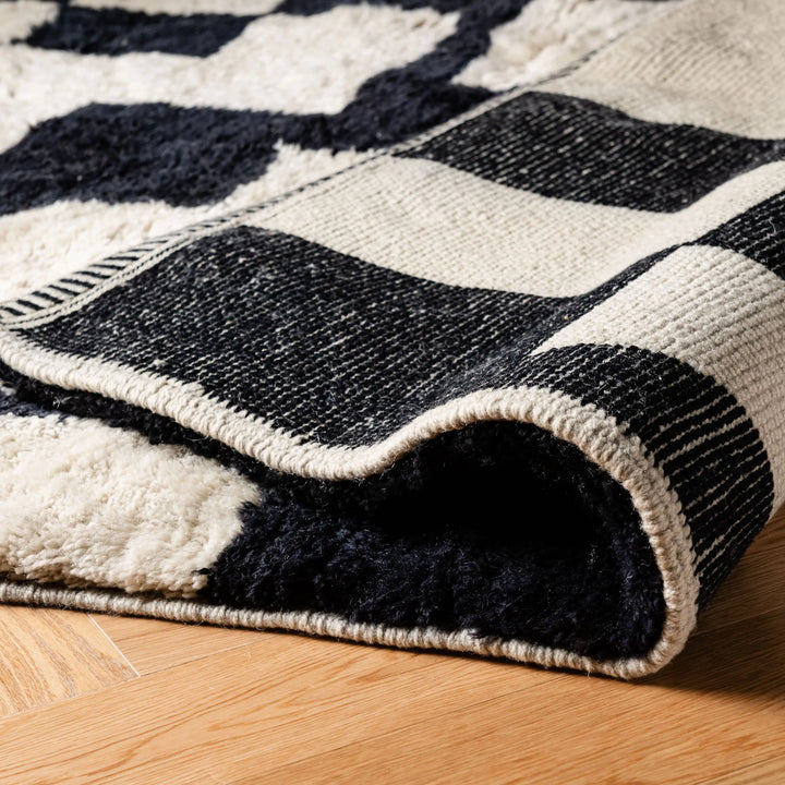 Custom Beni Mrirt Moroccan rug with abstract black and cream design, showcasing plush wool texture and modern geometric style.