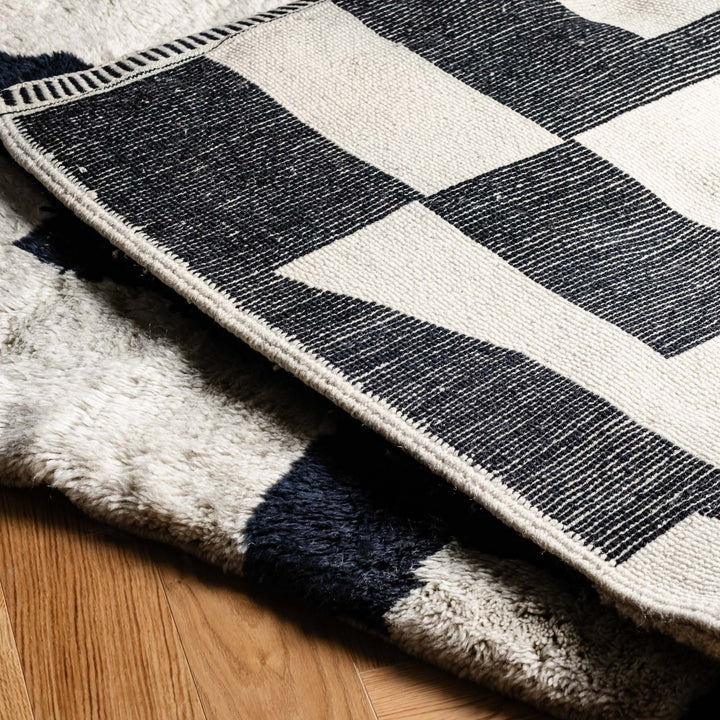 Custom Beni Mrirt rug, abstract black and cream design, handwoven Moroccan wool, geometric pattern, modern artistic flair.