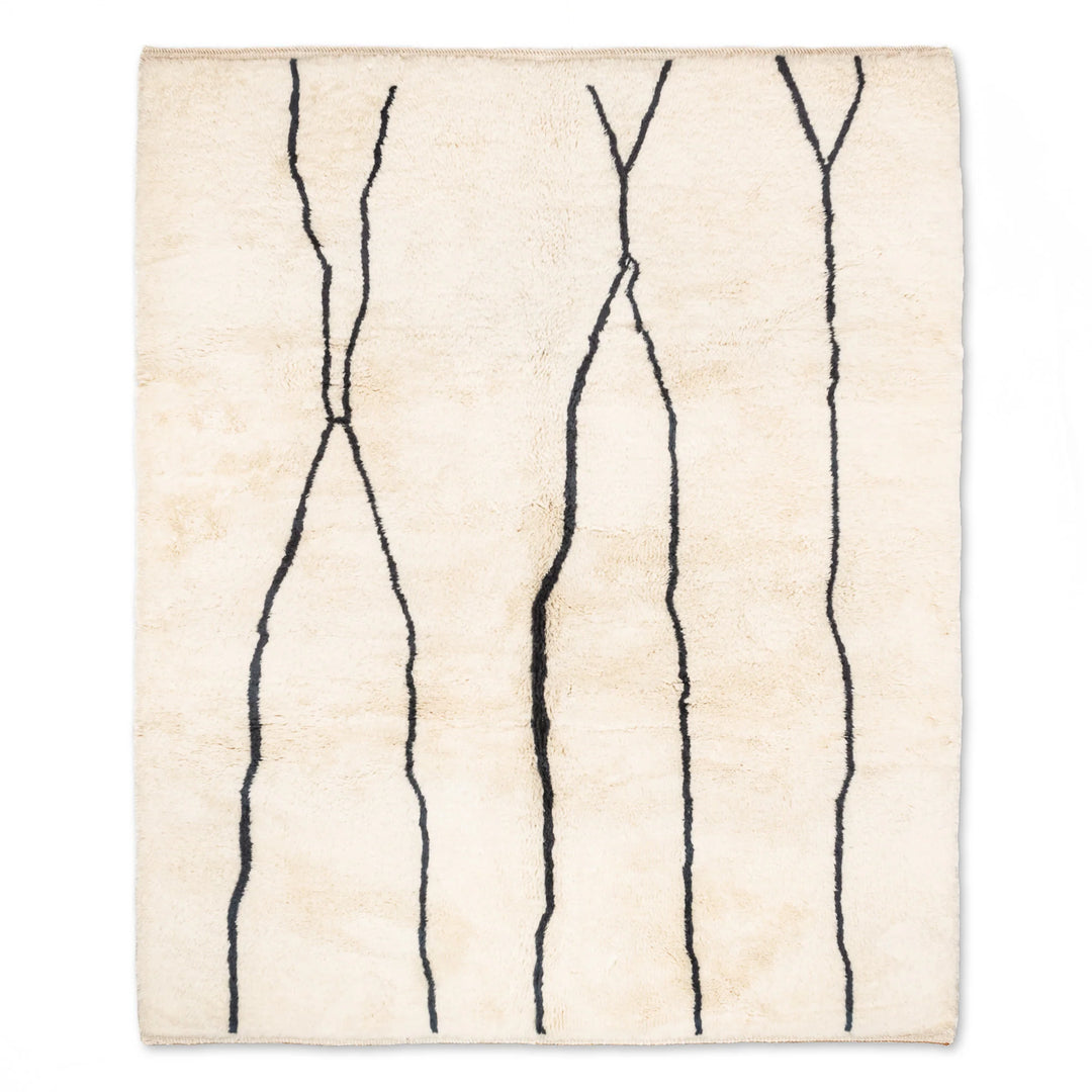 Custom Beni Mrirt Moroccan rug with black abstract lines, handcrafted wool elegance, traditional Berber motifs. Ideal for modern spaces.