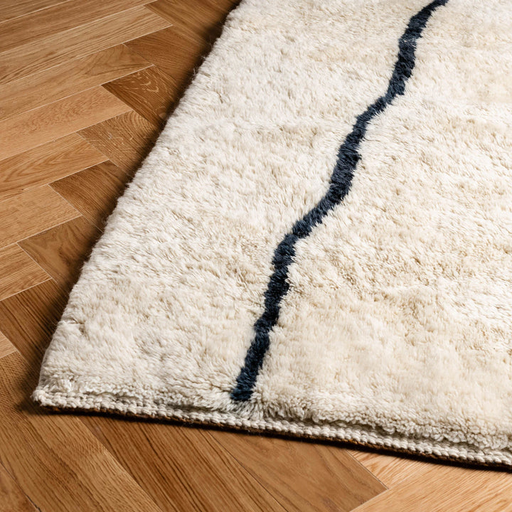 Custom Beni Mrirt Moroccan wool rug with abstract linear motif on wooden floor