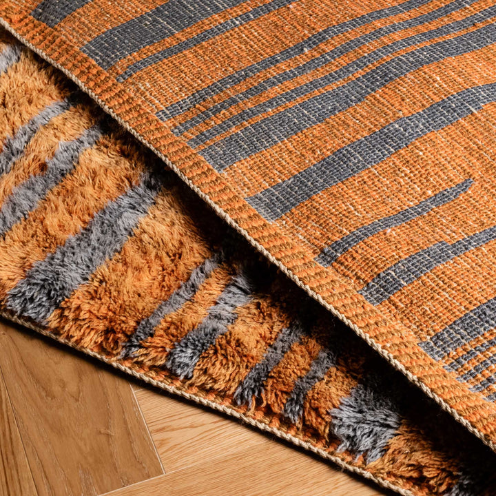 Custom Beni Mrirt Moroccan wool rug with handwoven vertical lines, showcasing orange and gray striped design.