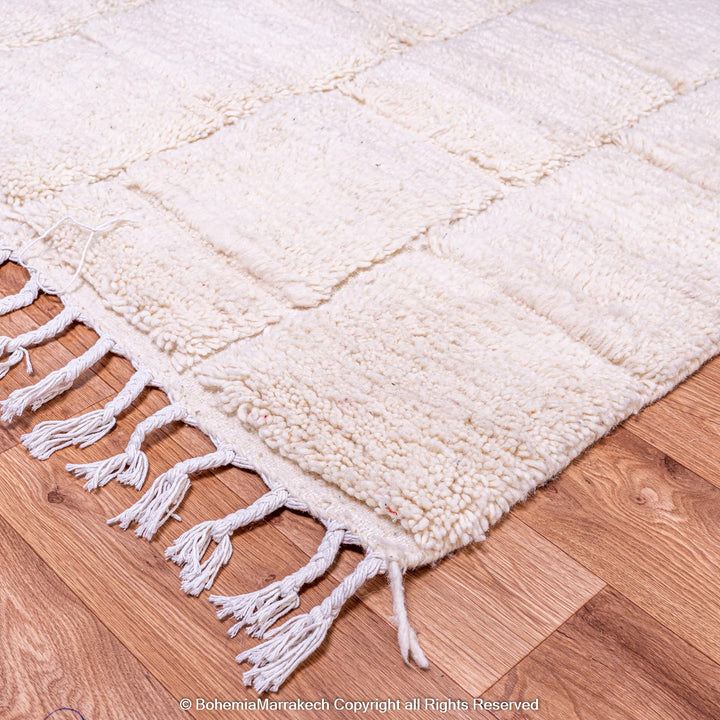 Cream Moroccan rug with minimalist grid pattern made from handwoven wool