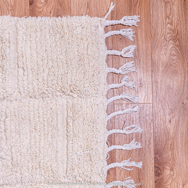 Cream Moroccan rug with minimalist grid pattern made from handwoven wool