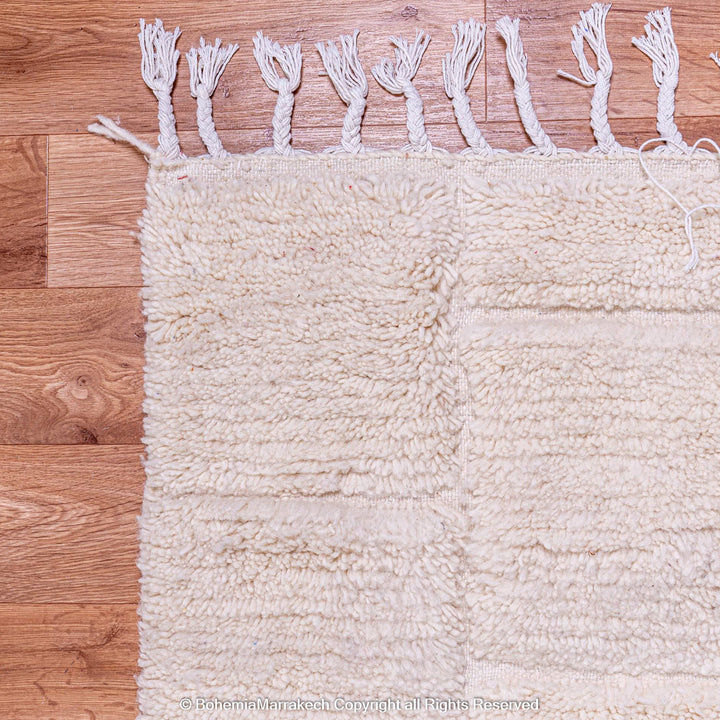 Cream Moroccan rug with minimalist grid pattern made from handwoven wool