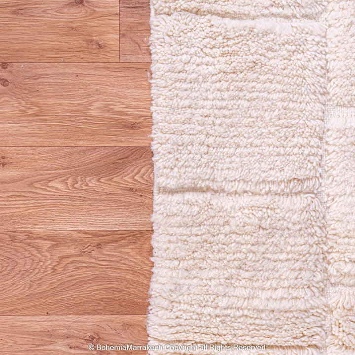 Cream Moroccan rug with minimalist grid pattern made from handwoven wool