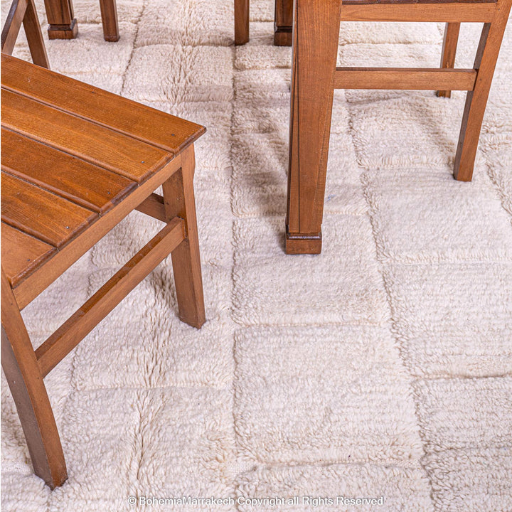 Cream Moroccan rug with minimalist grid pattern made from handwoven wool