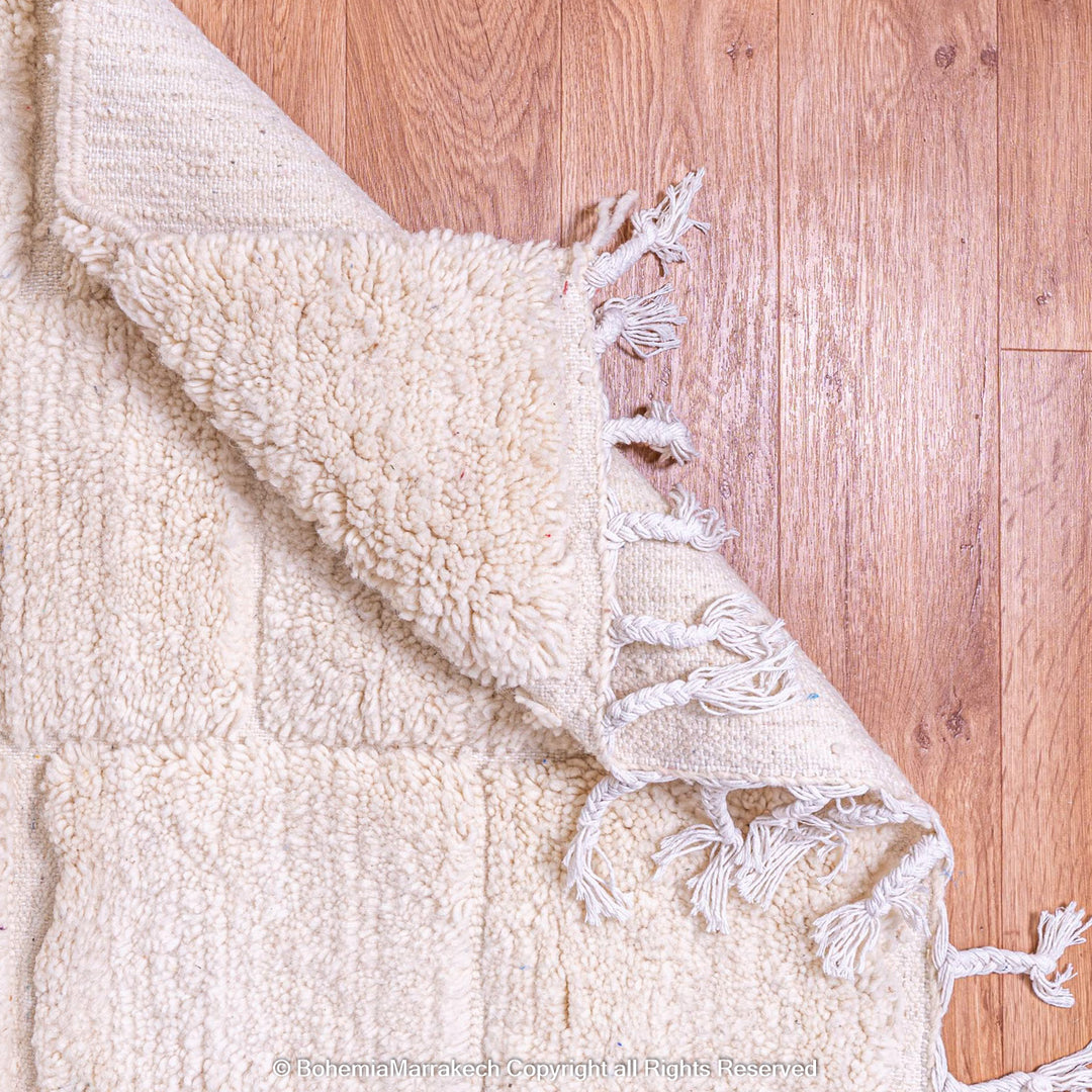 Cream Moroccan rug with minimalist grid pattern made from handwoven wool