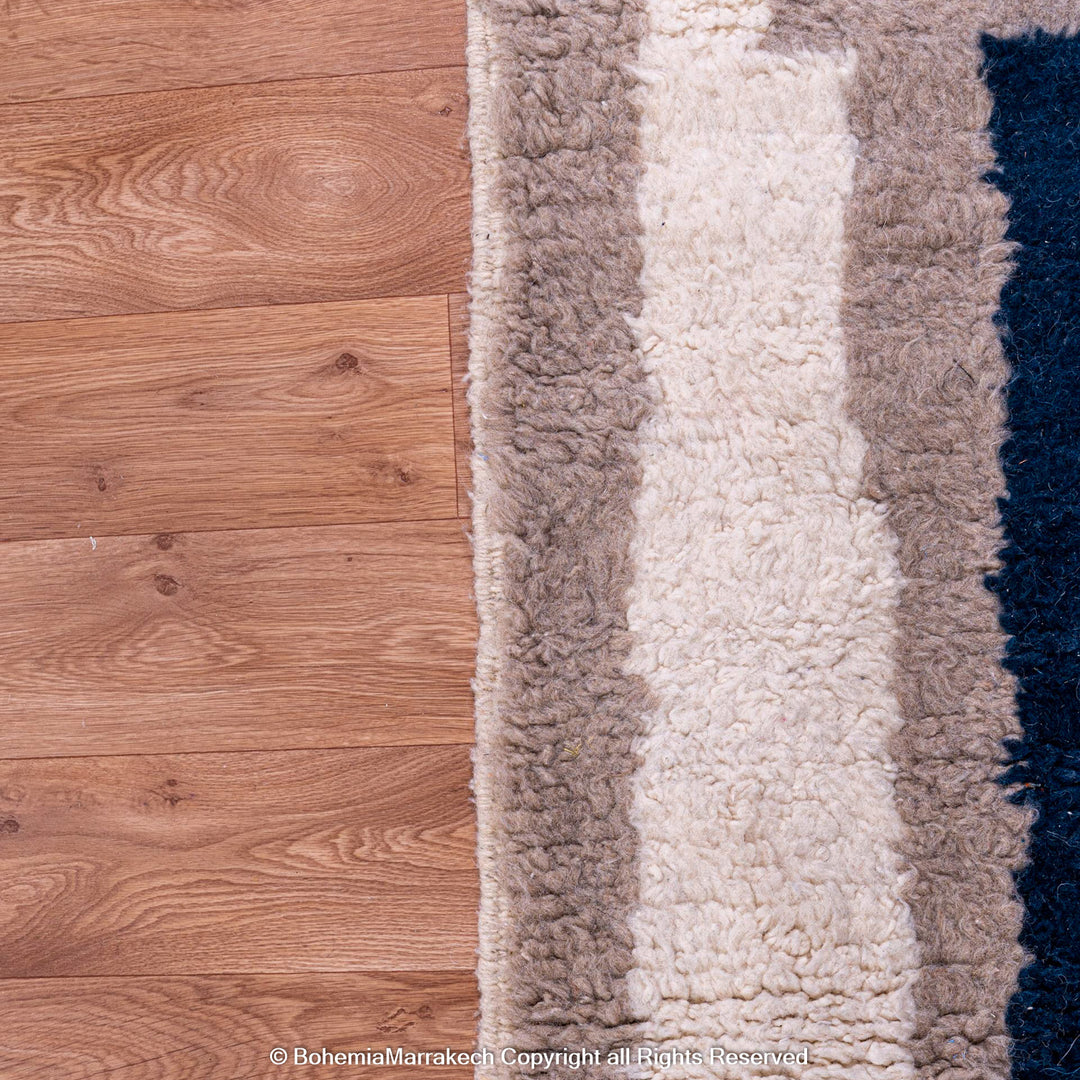 Bold navy blue Moroccan rug with beige and cream geometric border – Beni Ourain wool