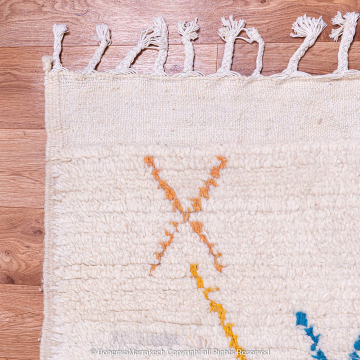 Minimal handmade Moroccan rug with diamond Berber motifs on white wool