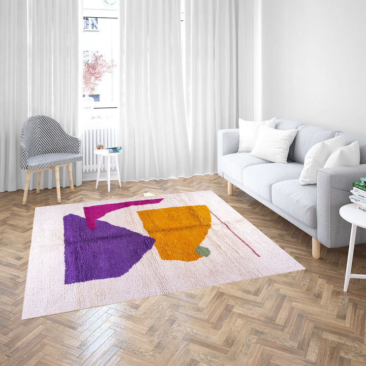 Abstract Moroccan wool rug with orange and purple geometric shapes on cream background