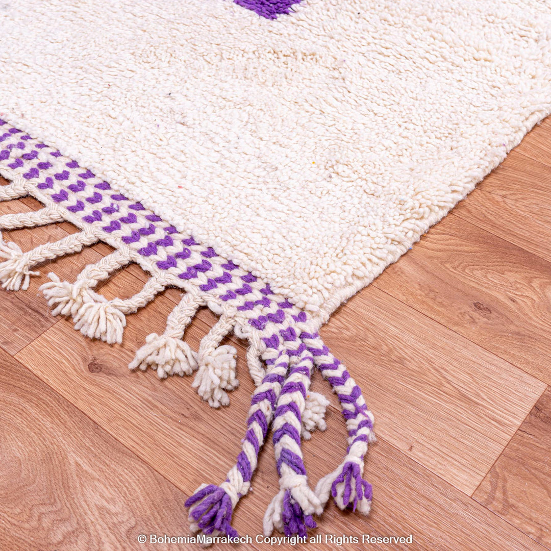 Abstract Moroccan wool rug with orange and purple geometric shapes on cream background