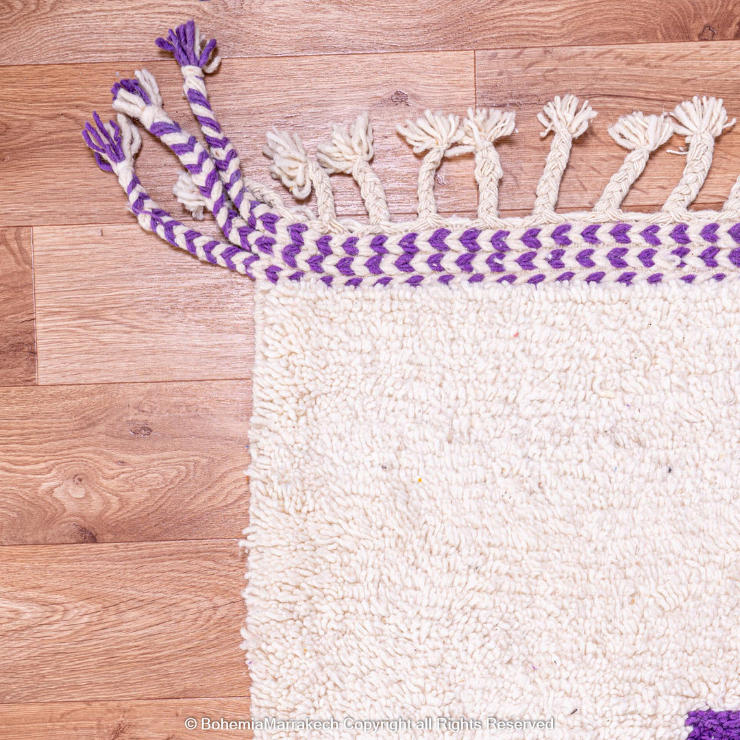 Abstract Moroccan wool rug with orange and purple geometric shapes on cream background