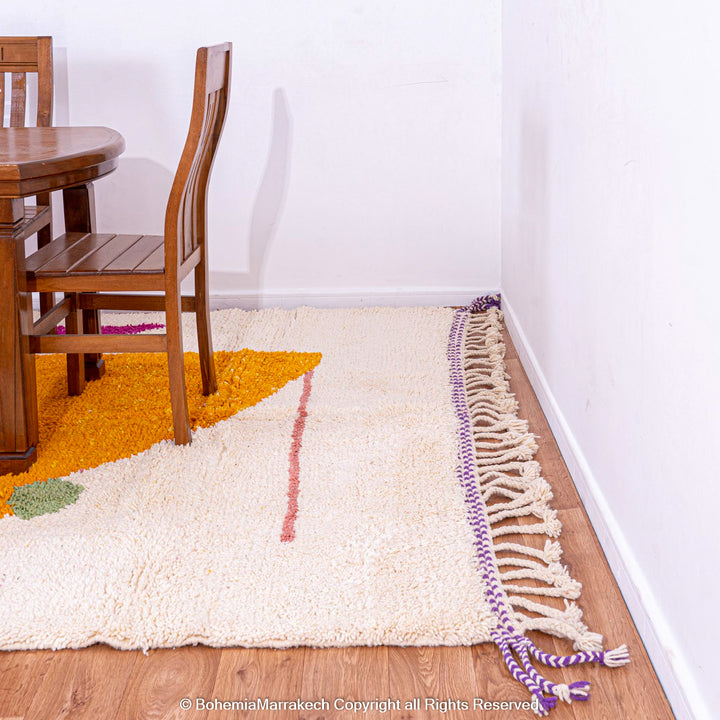 Abstract Moroccan wool rug with orange and purple geometric shapes on cream background
