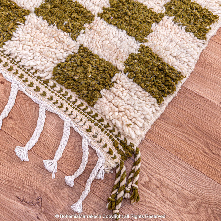 Shop a green white checkered Moroccan wool rug. Handwoven, bold, and stylish. Perfect for modern, boho, or traditional interiors.