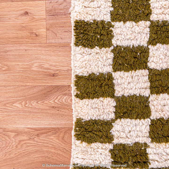 Shop a green white checkered Moroccan wool rug. Handwoven, bold, and stylish. Perfect for modern, boho, or traditional interiors.