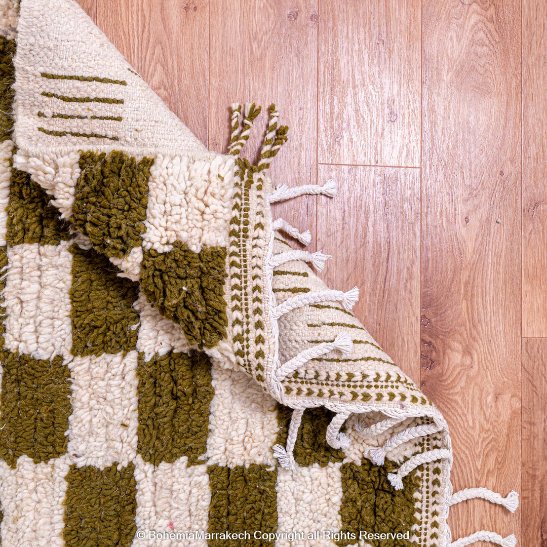 Shop a green white checkered Moroccan wool rug. Handwoven, bold, and stylish. Perfect for modern, boho, or traditional interiors.