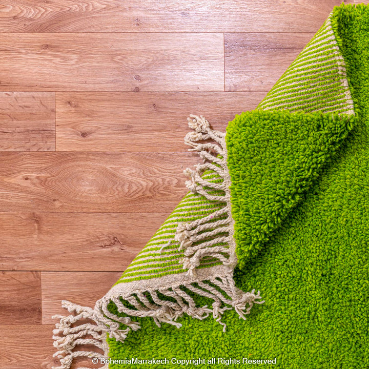 Solid green handmade Moroccan wool rug with white fringe, custom Beni Ourain carpet