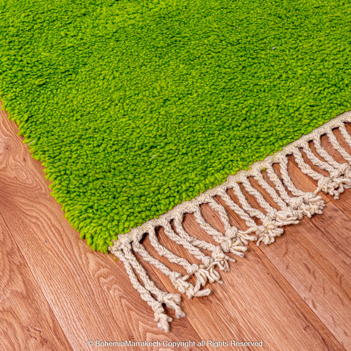 Solid green handmade Moroccan wool rug with white fringe, custom Beni Ourain carpet