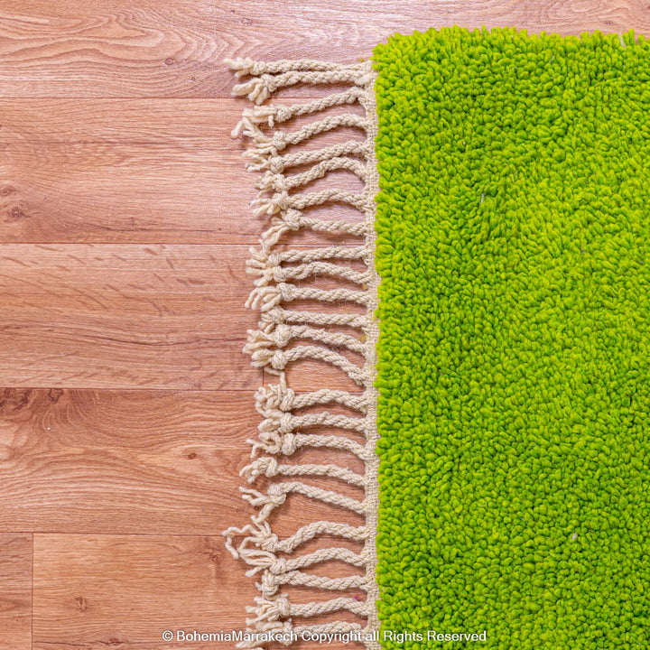 Solid green handmade Moroccan wool rug with white fringe, custom Beni Ourain carpet