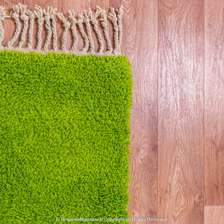 Solid green handmade Moroccan wool rug with white fringe, custom Beni Ourain carpet