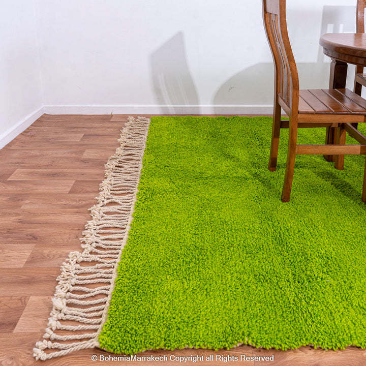 Solid green handmade Moroccan wool rug with white fringe, custom Beni Ourain carpet