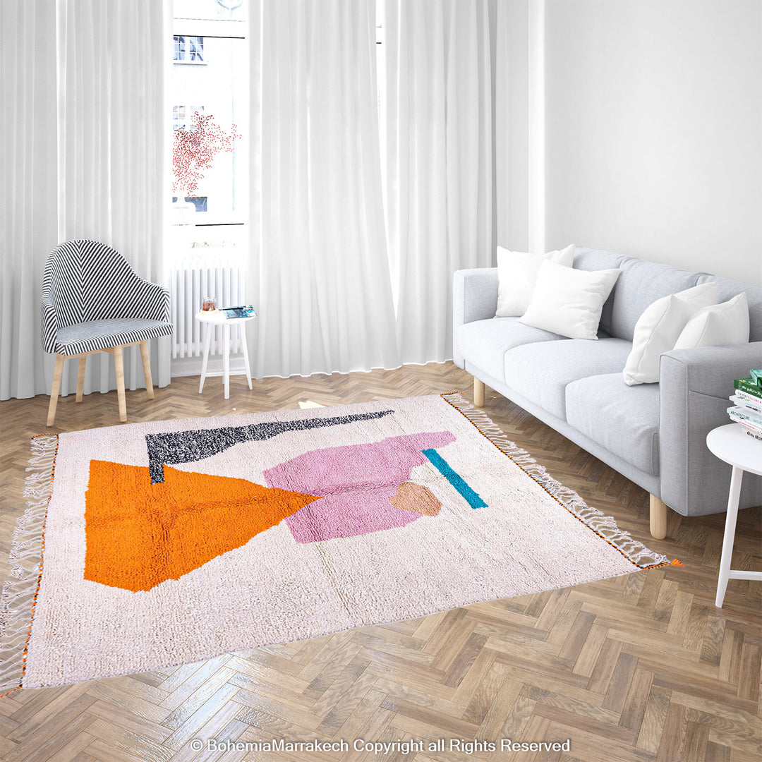 Abstract Beni Ourain Moroccan rug with colorful geometric shapes in orange, pink, black, and teal on a white wool background