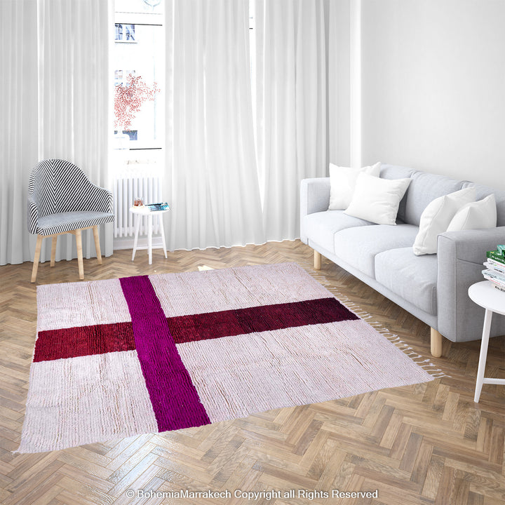Handmade Moroccan wool rug with burgundy and magenta cross on ivory background – Beni Ourain style