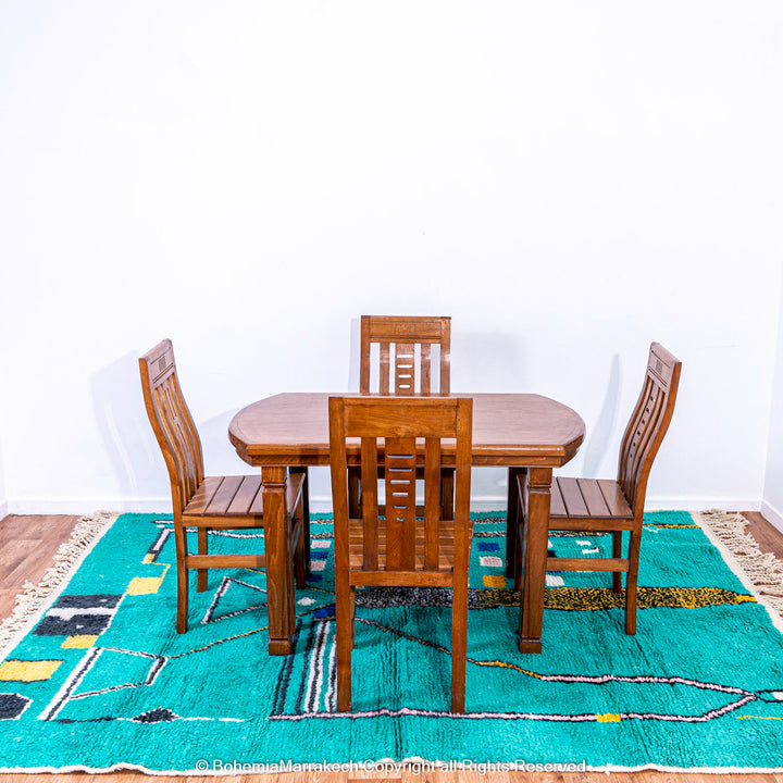 Handmade green Moroccan rug with bright diamond line patterns on deep green background